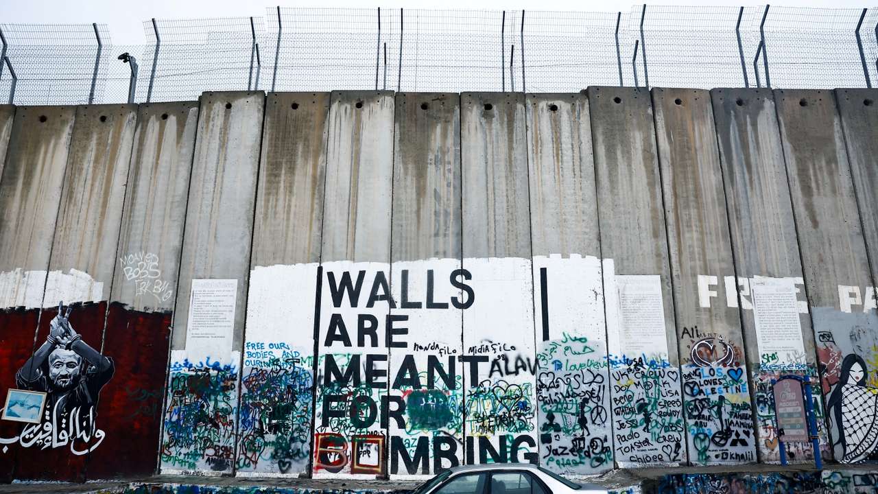 FILE PHOTO: A car is parked next to the Israeli wall in Bethlehem