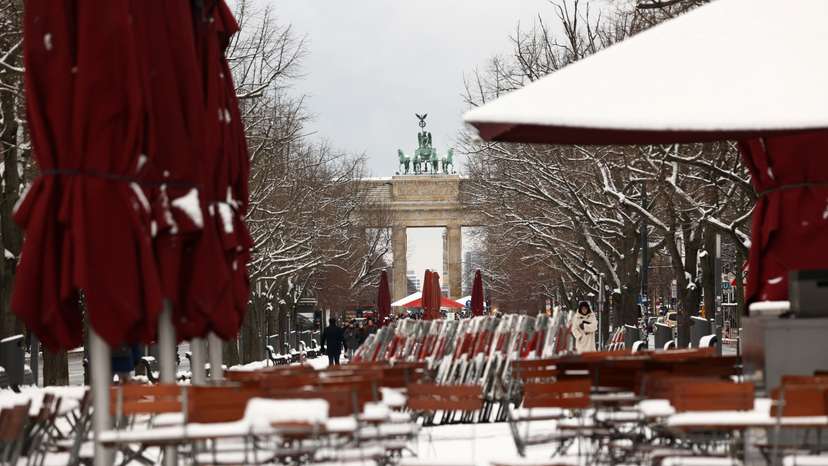 FILE PHOTO: Snow covers the streets and tables near the Brandenburg Gate in Berlin
