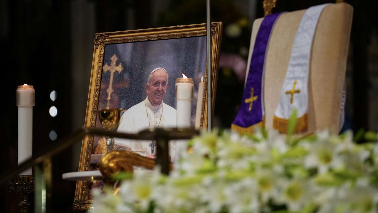 A photo of Pope Francis is kept on display as people attend morning mass after the death of Pope Francis was announced by the Vatican, at St Patrick's Cathedral in Manhattan in New York City, U.S. April 21, 2025. REUTERS/Adam Gray