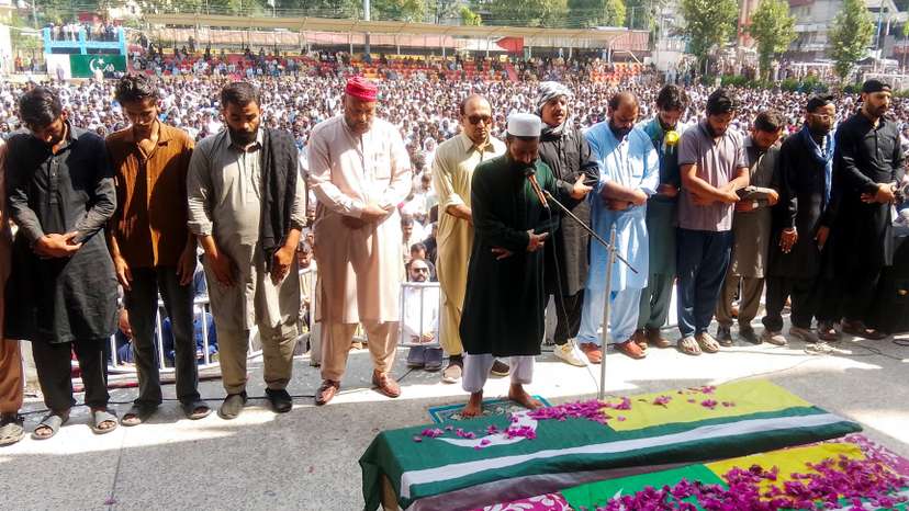 People attend the funeral of men, who were killed during a protest following a shutter-down strike in Muzaffarabad