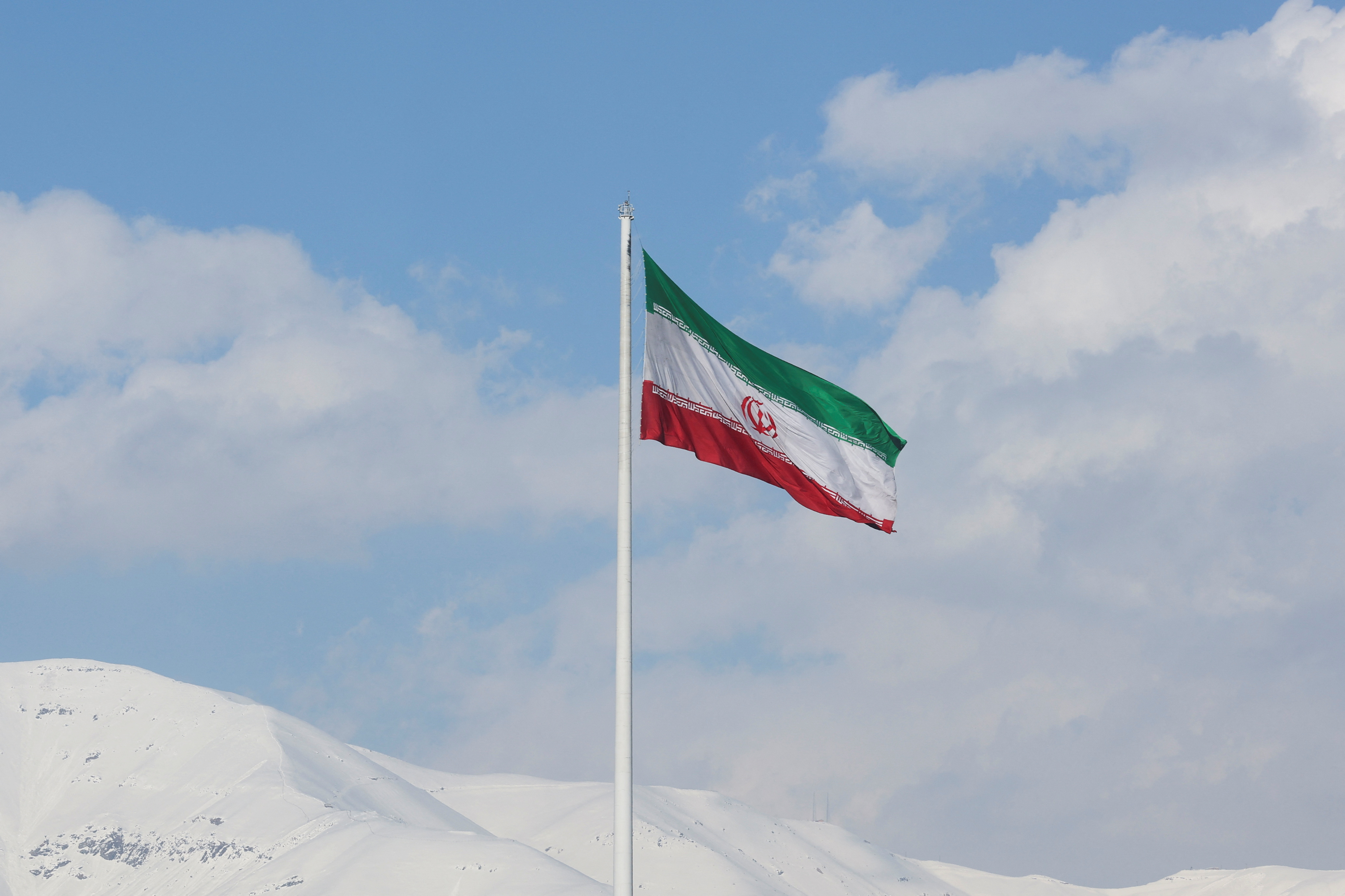 FILE PHOTO: The Iranian flag is seen flying over a street in Tehran