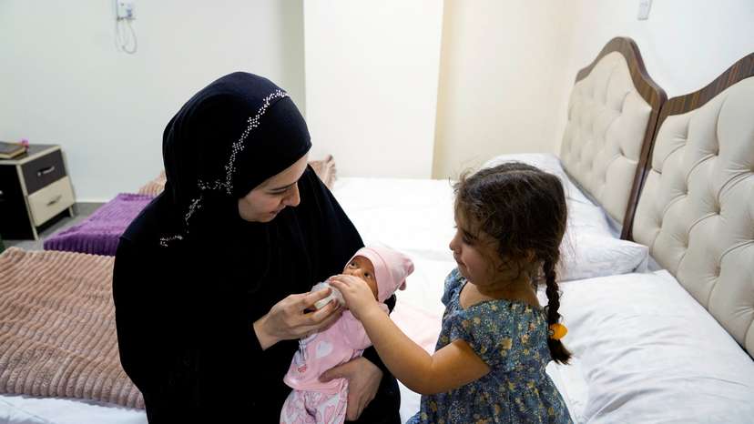 Lubana Ismail, a displaced Lebanese woman holds her newborn baby girl, to whom she gave birth in Iraq, in Najaf