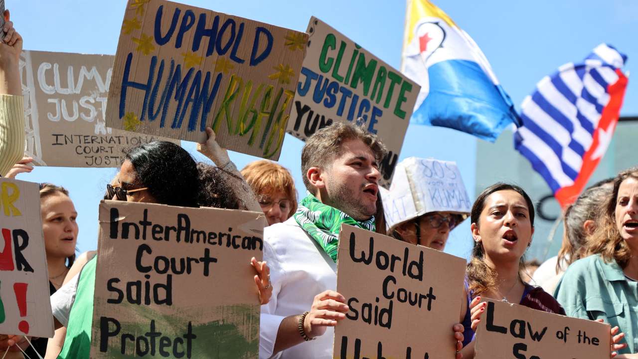 Climate activists and campaigners demonstrate outside the International Court of Justice (ICJ) in The Hague