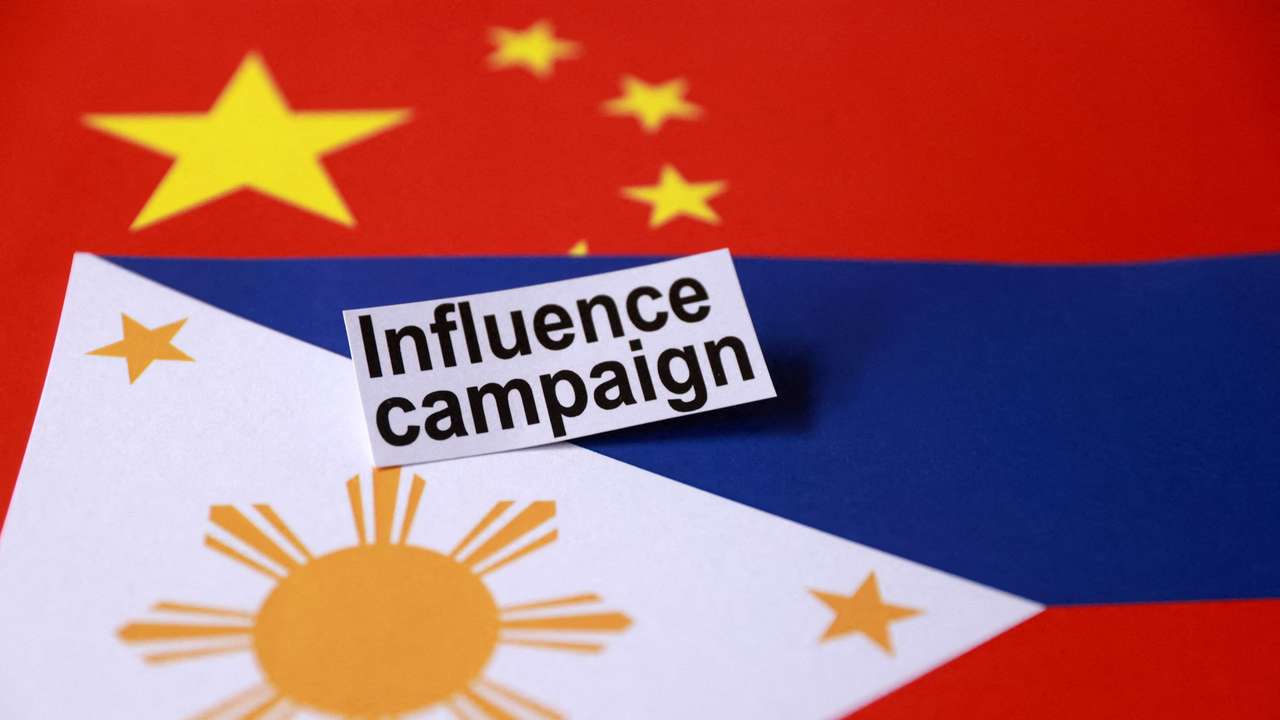 FILE PHOTO: Illustration shows a sign reading "Influence campaign" and Chinese and Philippines flags
