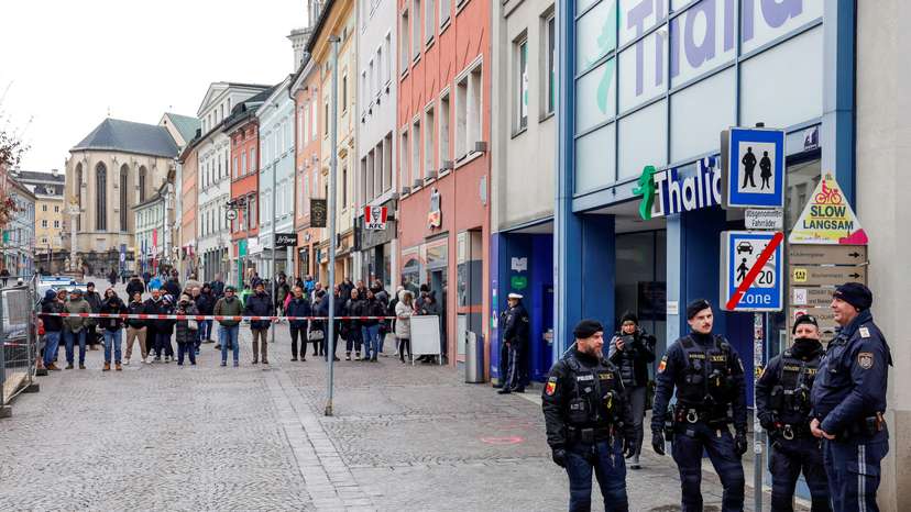 FILE PHOTO: Police officers stand guard at the scene where a 14-year-old boy was killed and several others were wounded in a stabbing attack, in the town of Villach