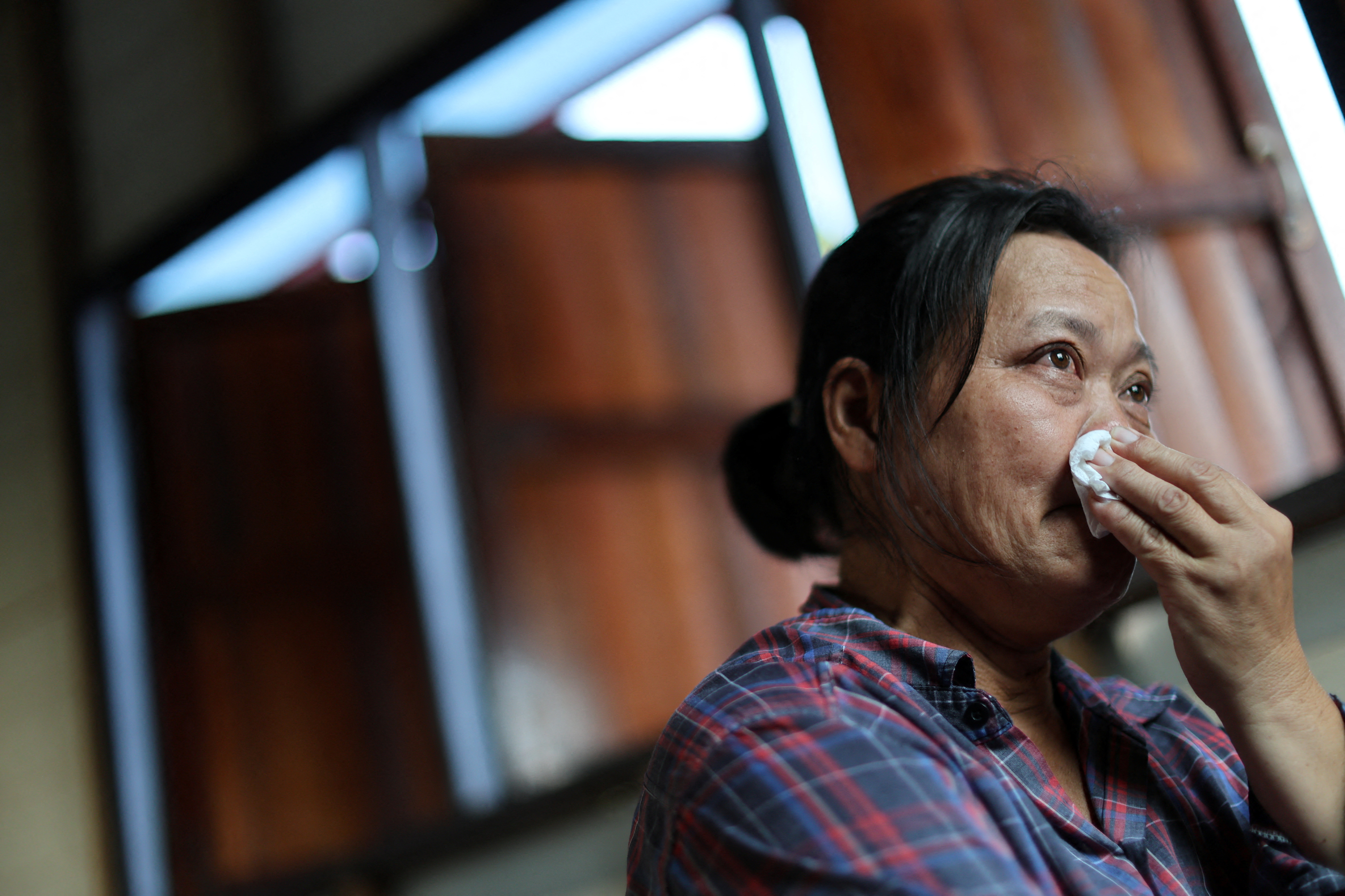 Wiwwaro Sriaoun, mother of a remaining Thai hostage captured by Hamas, Watchara Sriaoun, reacts during an interview with Reuters