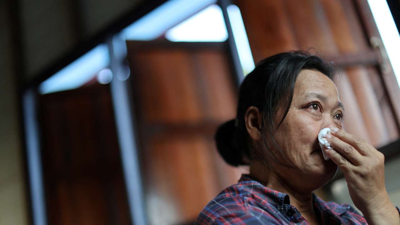 Wiwwaro Sriaoun, mother of a remaining Thai hostage captured by Hamas, Watchara Sriaoun, reacts during an interview with Reuters