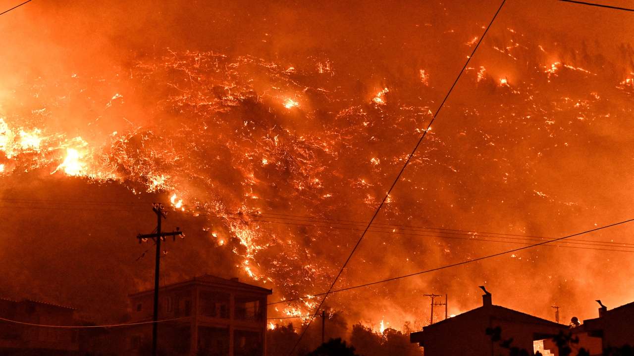 Wildfire burns next to the village of Ano Loutro, near Corinth