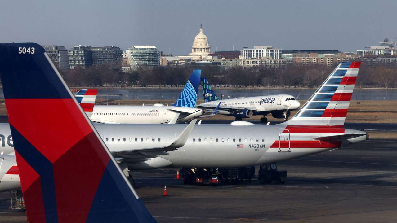 FILE PHOTO: A JetBlue aircraft lands under the DC skyline featuring the U.S. Capitol building