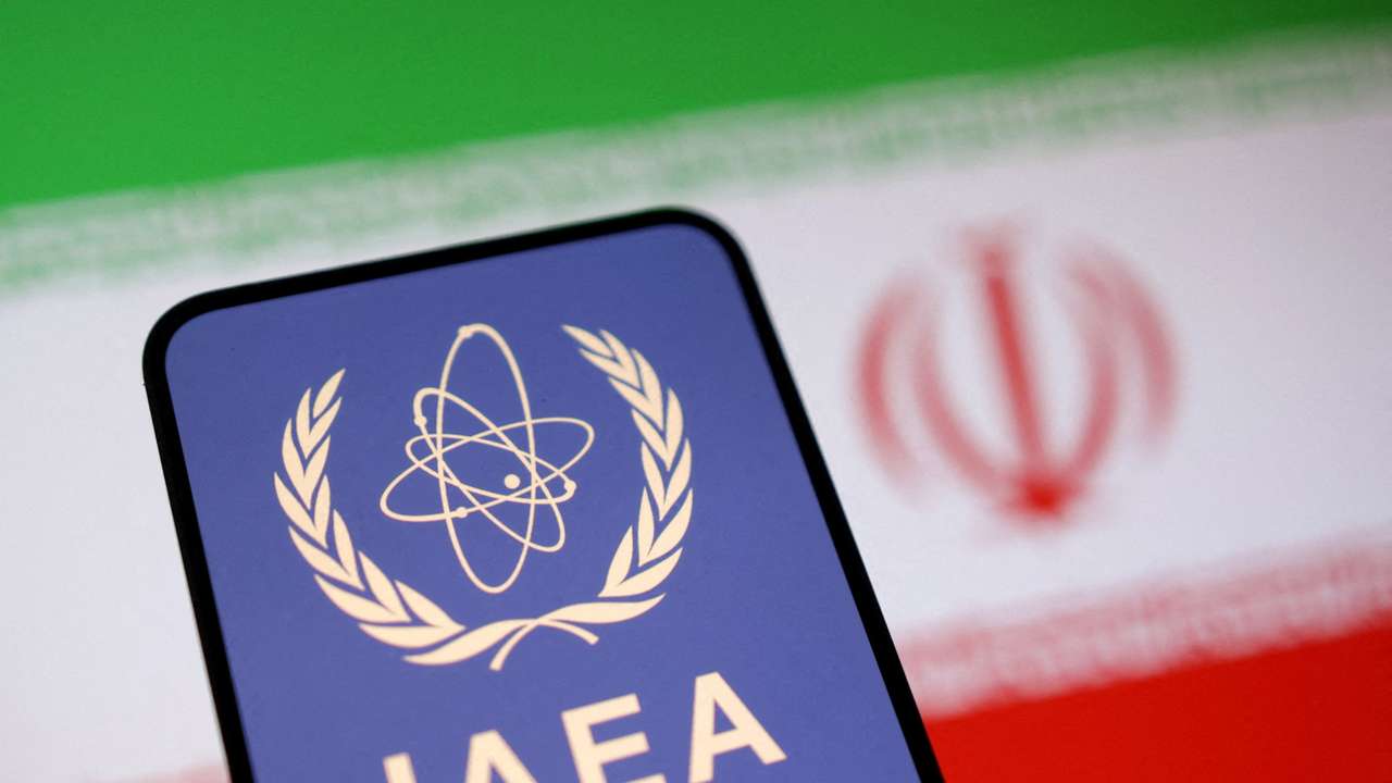 FILE PHOTO: Illustration shows International Atomic Energy Agency (IAEA) logo and Iranian flag