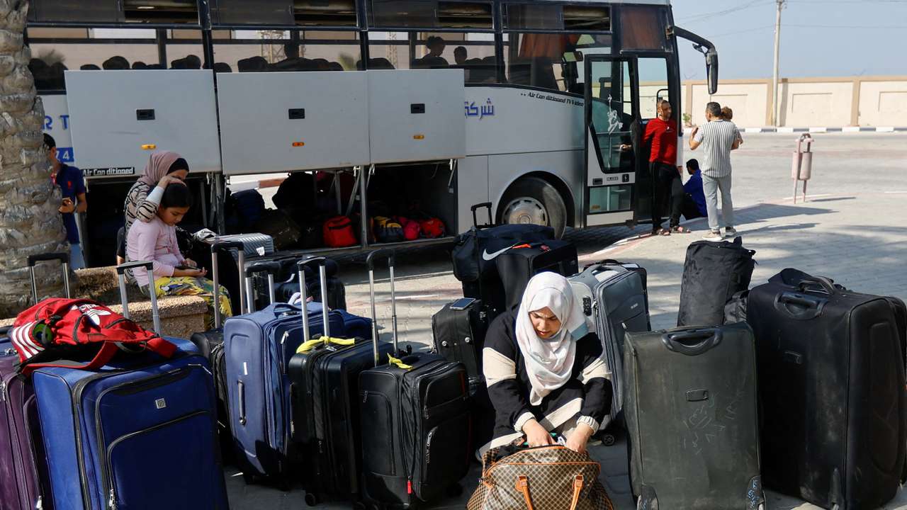 FILE PHOTO: Palestinians holding foreign passports wait for permission to leave Gaza, at the Rafah border crossing with Egypt