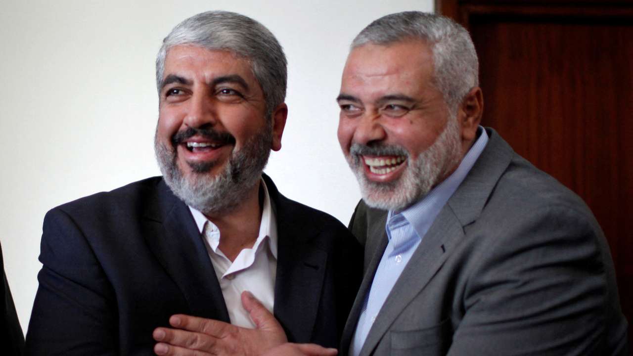 FILE PHOTO: Hamas chief Khaled Meshaal hugs senior Hamas leader Ismail Haniyeh before leaving Gaza Strip