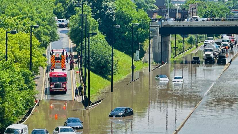 A cyclist views a flooded section of the Don Valley Parkway after heavy rains hit Toronto