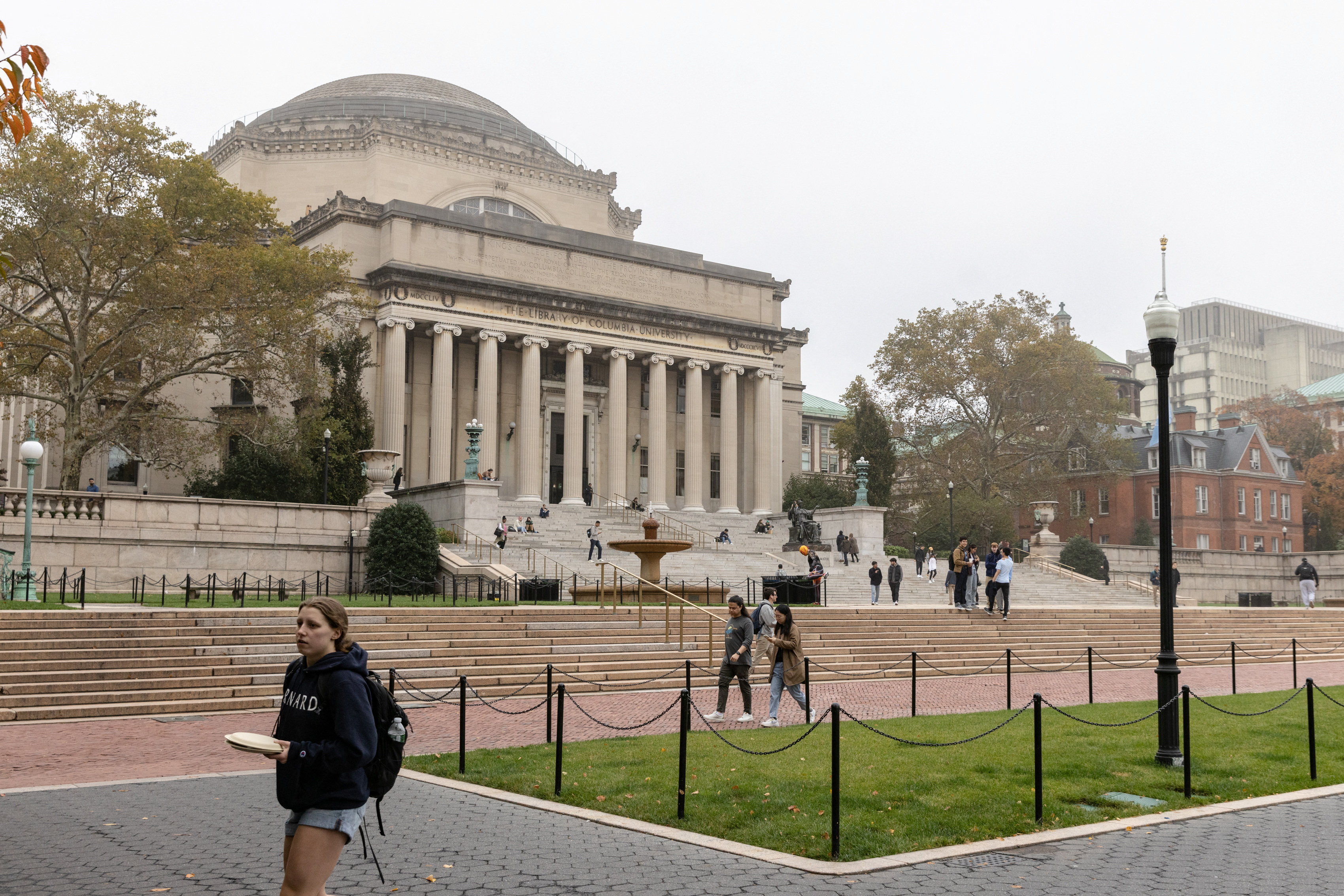People walk past Columbia University in New York