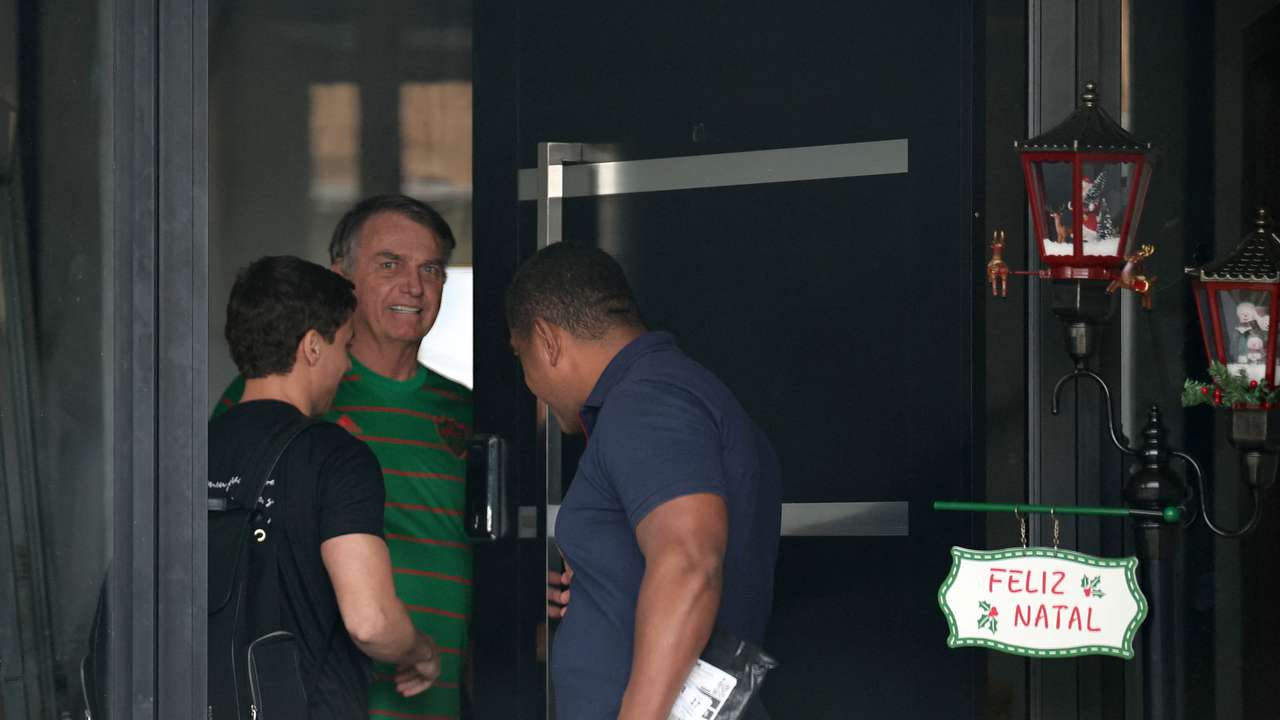 Brazil's former President Jair Bolsonaro appears in the doorway of his house, during his house arrest, in Brasilia, Brazil, November 21, 2025. REUTERS/Mateus Bonomi