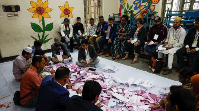 Officials sort the ballots before counting the votes, during the 13th general election in Dhaka, Bangladesh, February 12, 2026. REUTERS/Mohammad Ponir Hossain