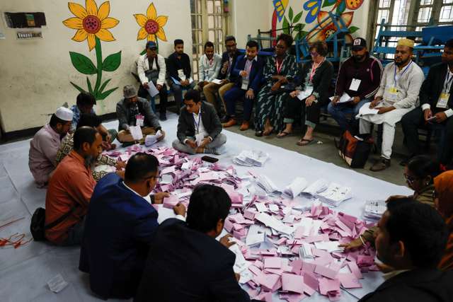 Officials sort the ballots before counting the votes, during the 13th general election in Dhaka, Bangladesh, February 12, 2026. REUTERS/Mohammad Ponir Hossain