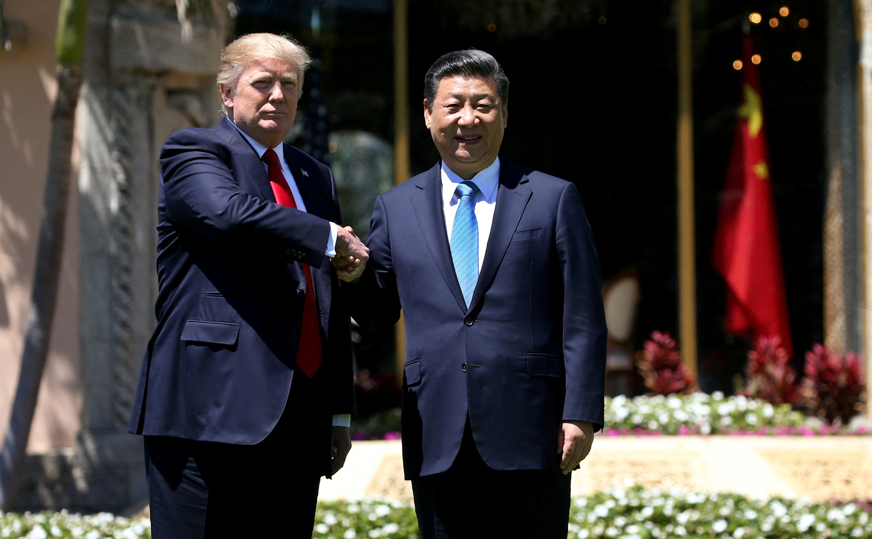 U.S. President Trump and China's President Xi  shake hands during walk at the Mar-a-Lago estate after a bilateral meeting in Palm Beach