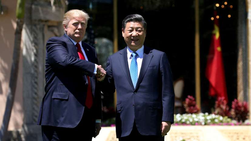 U.S. President Trump and China's President Xi shake hands during walk at the Mar-a-Lago estate after a bilateral meeting in Palm Beach
