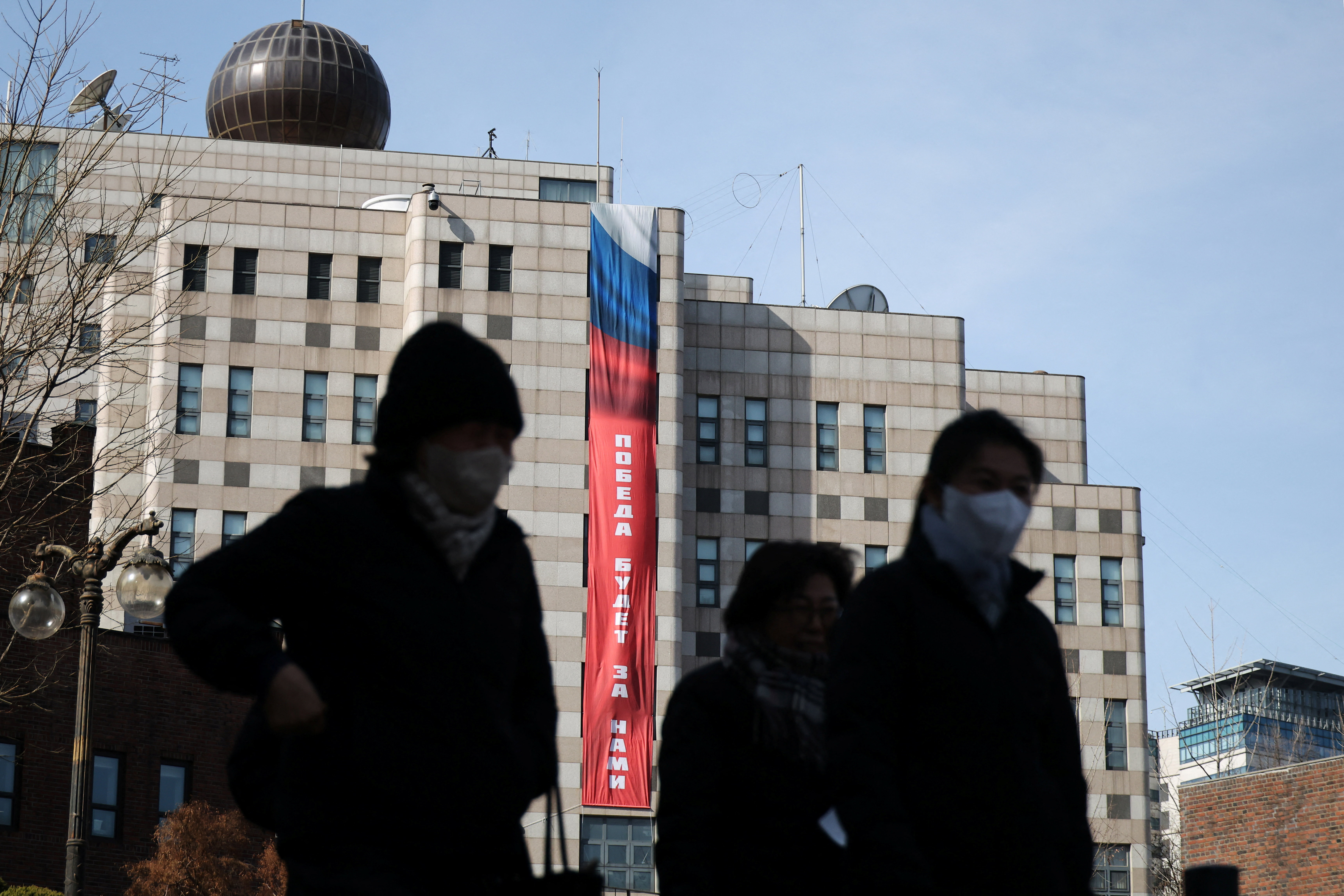 A banner that reads "Victory will be ours" hangs on the exterior of the Russian Embassy in Seoul