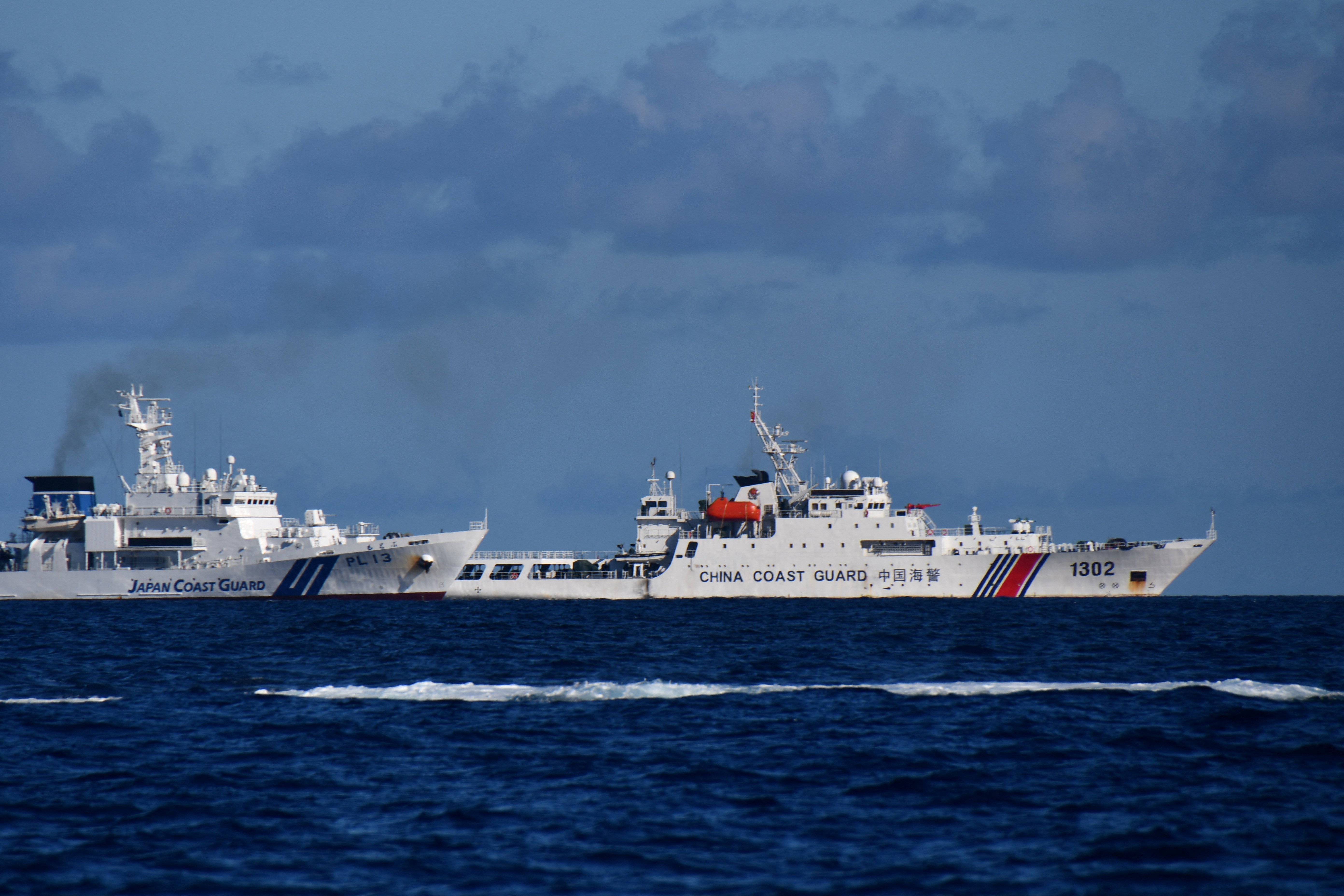 A China Coast Guard vessel sails near a Japan Coast Guard vessel around a group of disputed islands called Senkaku Islands in Japan, also known in China as Diaoyu Islands