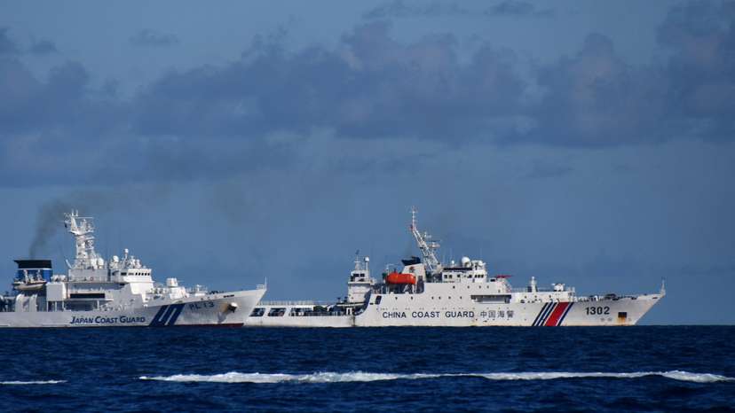 A China Coast Guard vessel sails near a Japan Coast Guard vessel around a group of disputed islands called Senkaku Islands in Japan, also known in China as Diaoyu Islands