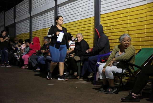 Venezuelans wait outside closed voting station to vote in presidential election, in Las Vegas de Tariba
