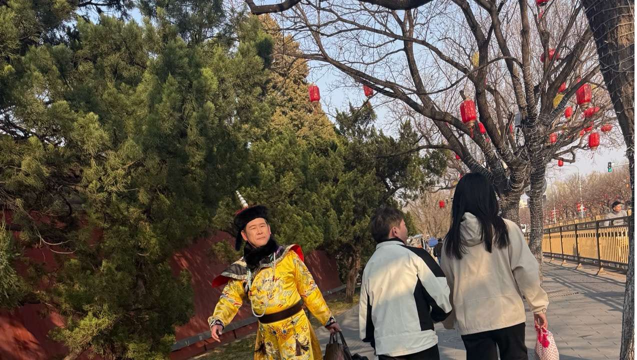 A man dressed as a Qing Dynasty emperor on a Beijing street