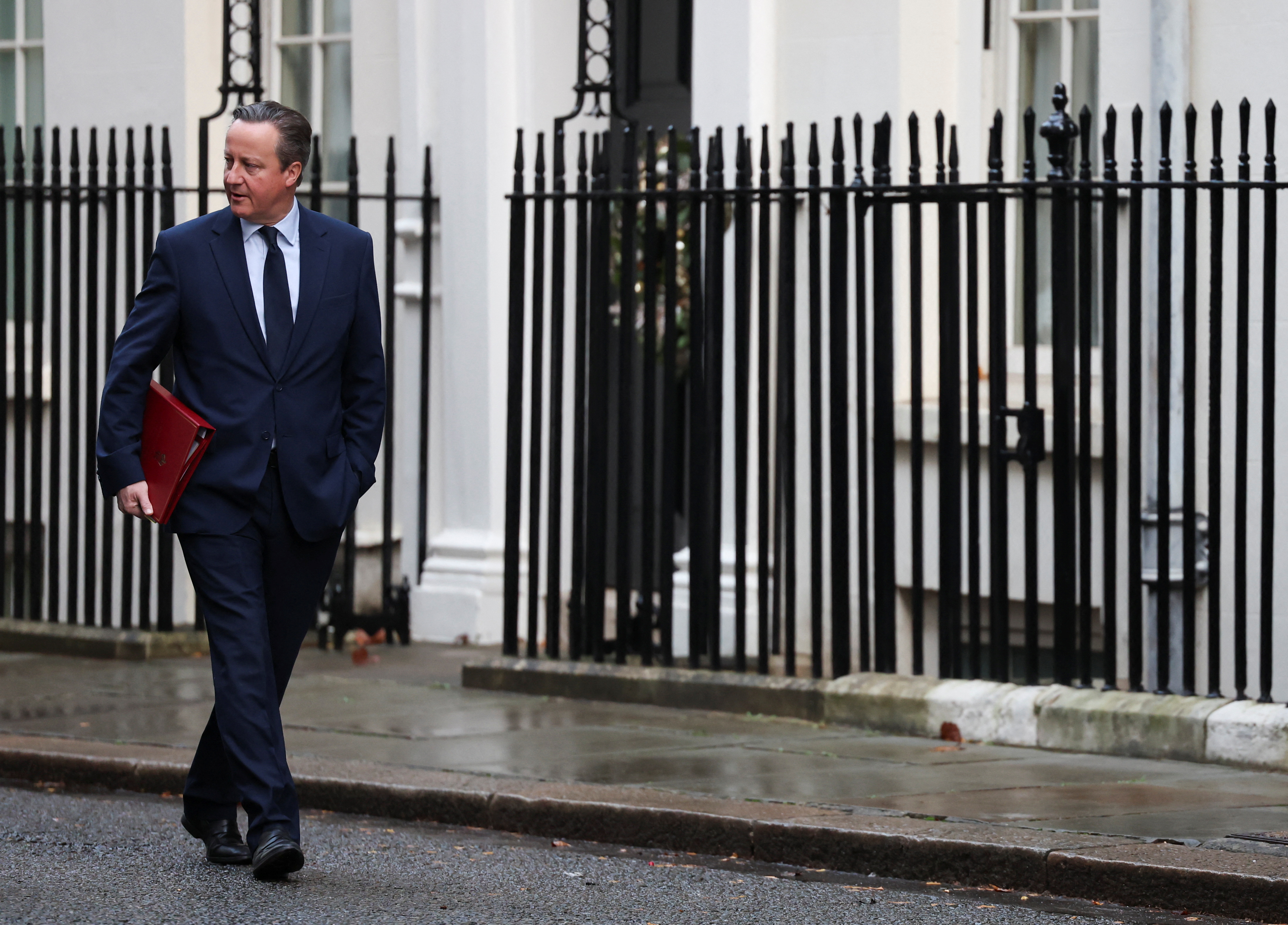 FILE PHOTO: British Secretary of State for Foreign, Commonwealth and Development Affairs David Cameron walks outside 10 Downing Street in London