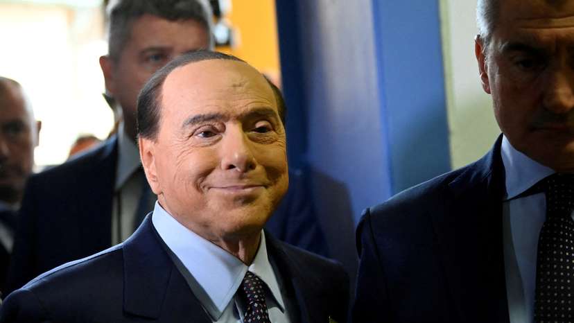 FILE PHOTO: Silvio Berlusconi walks at a polling station in Milan, Italy, September 25, 2022.