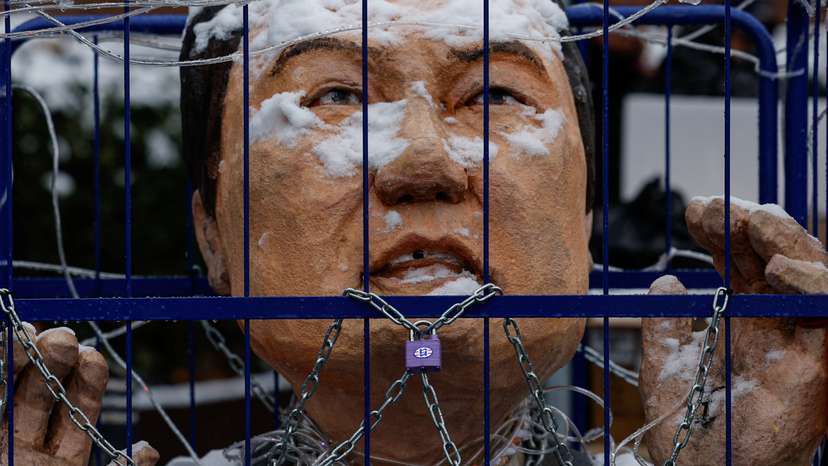 An effigy of impeached South Korean President Yoon Suk Yeol is covered in snow during a protest against him near his official residence on a snowy day in Seoul