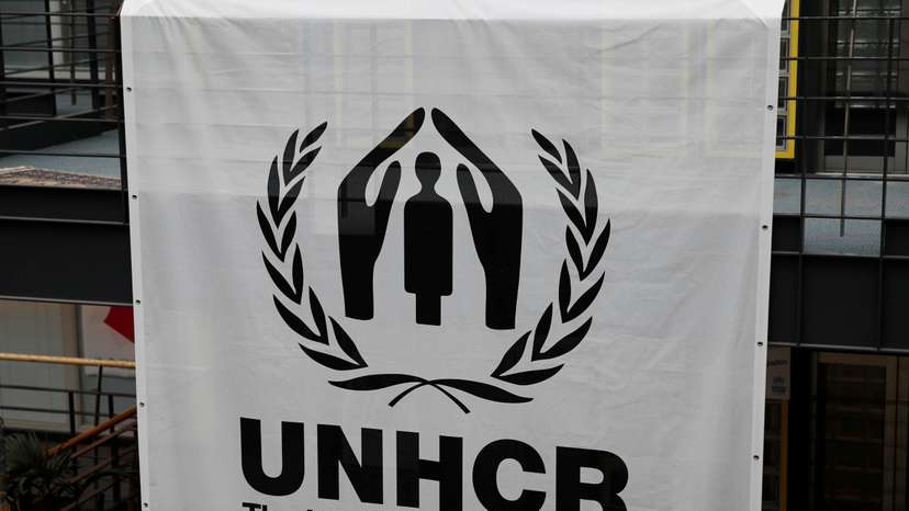 A logo is pictured on a banner at the UNHCR headquarters in Geneva