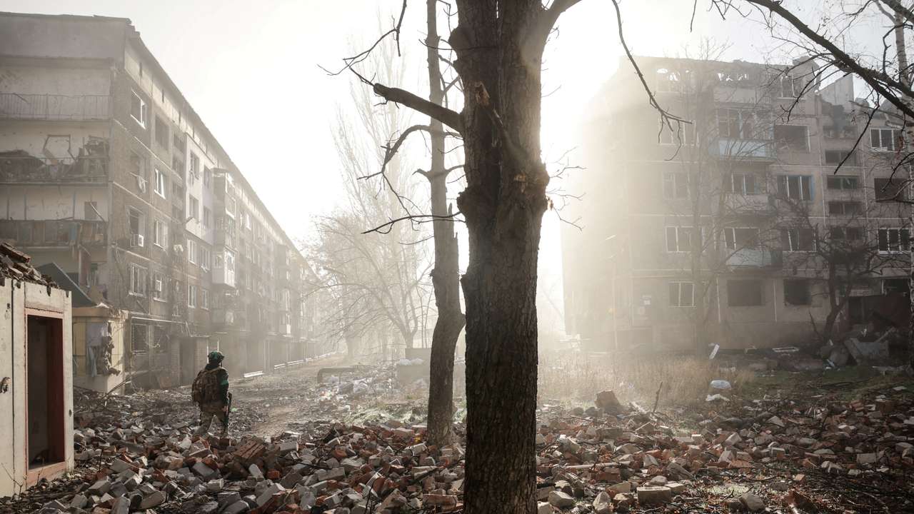 FILE PHOTO: Ukrainian serviceman walks near apartment buildings damaged by a Russian military strike in the frontline town of Kostiantynivka