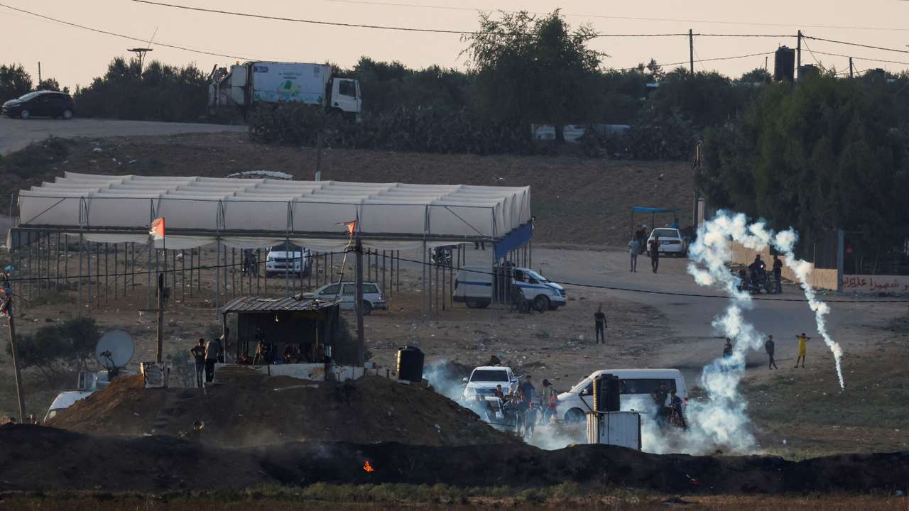 FILE PHOTO: Israeli soldiers and Palestinian protesters clash near the border between Israel and the Gaza Strip as seen from the Israeli side