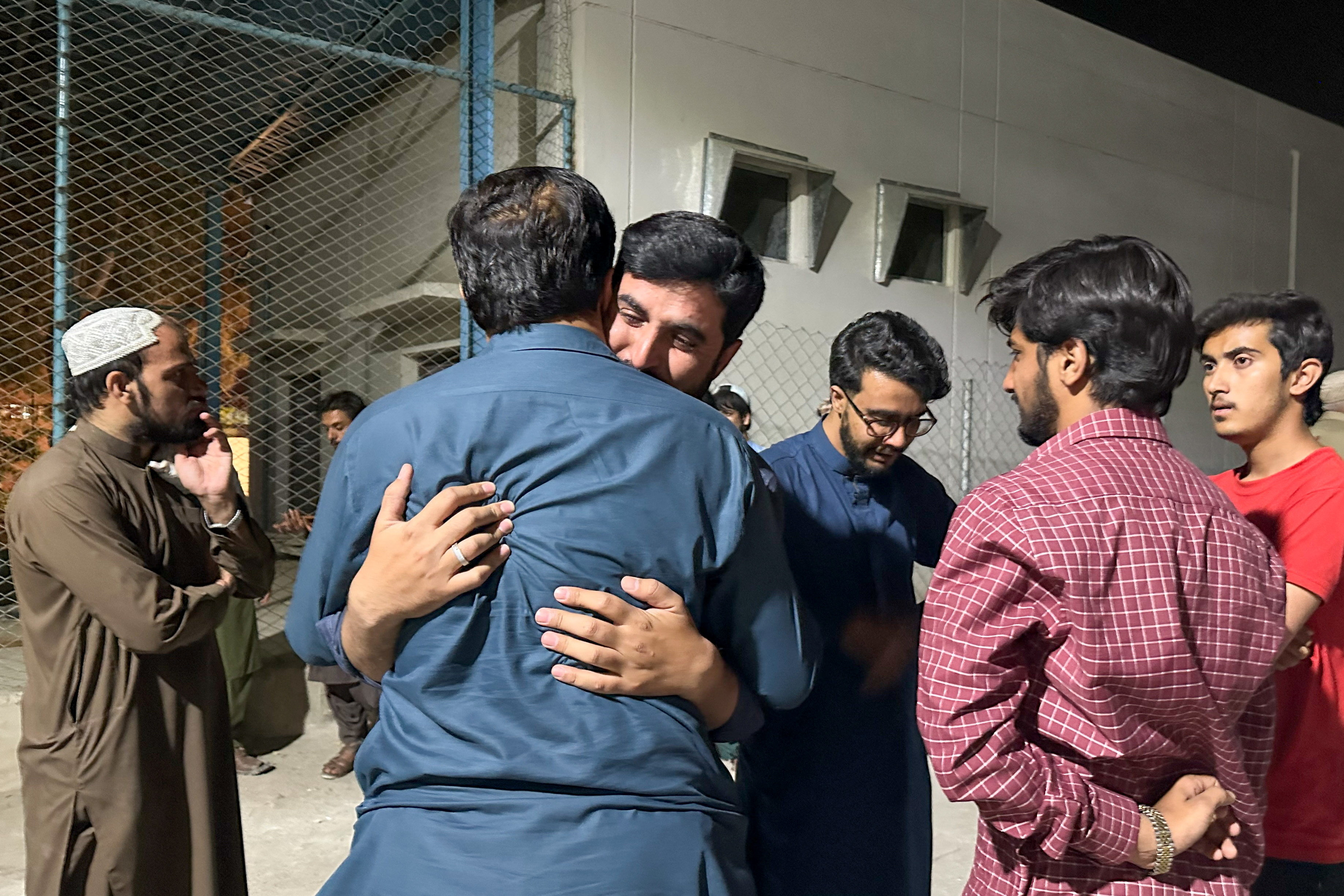 Men mourn the death of a relative, who was killed in a bomb blast at the public rally in Quetta, at hospital premises in Quetta