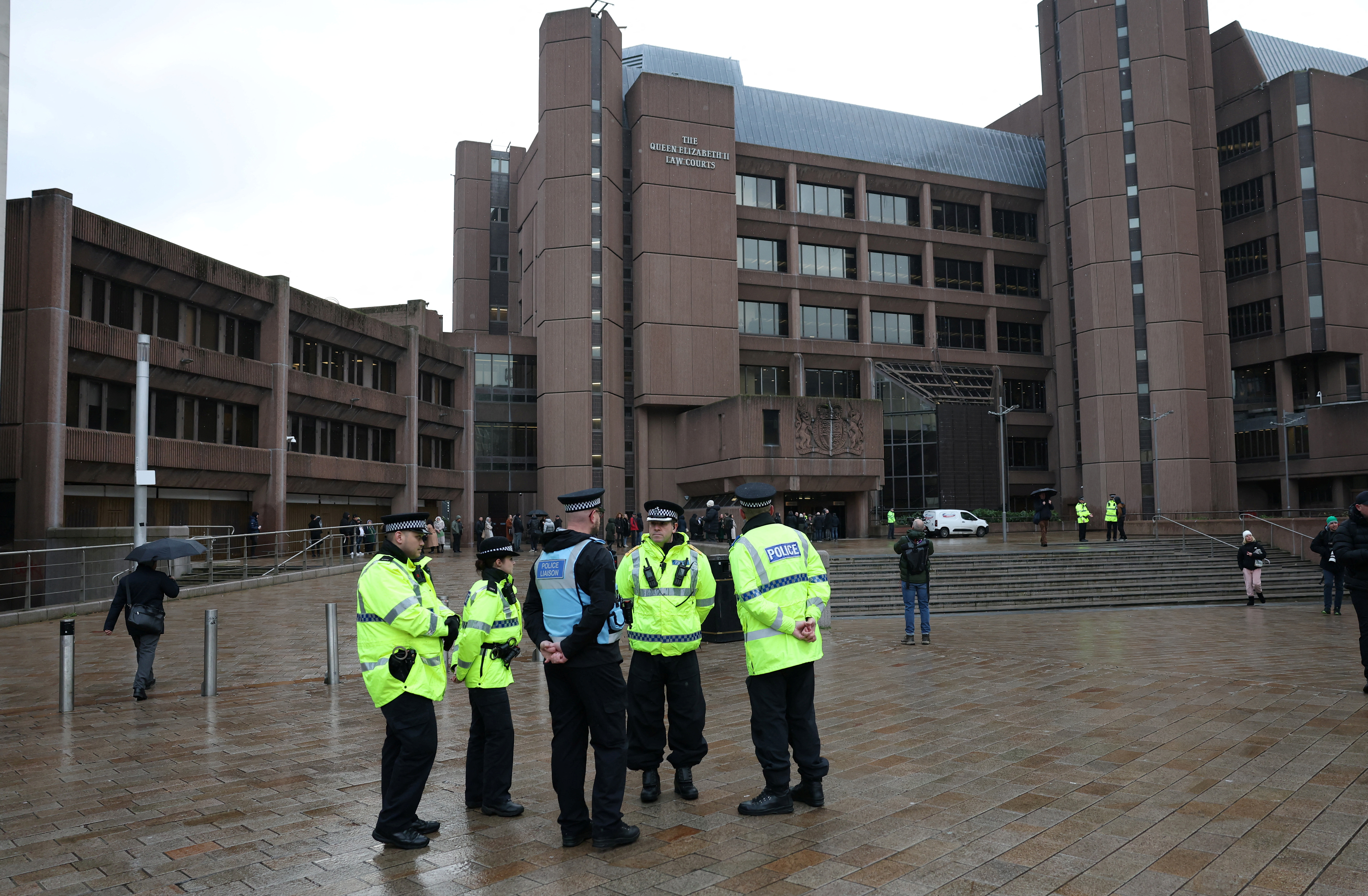 Police officers stand outside Liverpool Crown Court at the start of the trial of Rudakubana