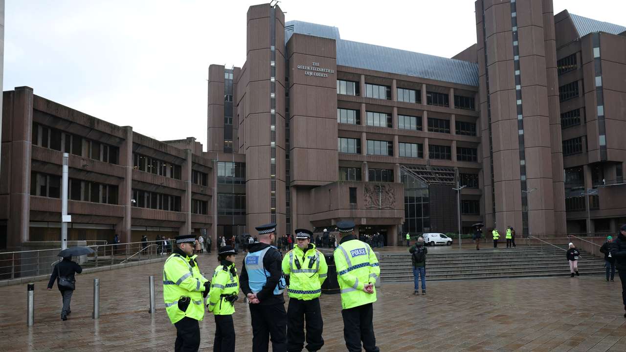 Police officers stand outside Liverpool Crown Court at the start of the trial of Rudakubana