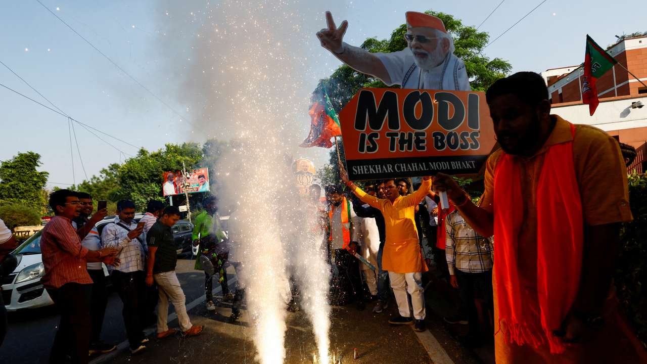 Bharatiya Janata Party (BJP) supporters celebrate outside the BJP headquarters, as the BJP leads in the election results in the northern state of Haryana, in New Delhi