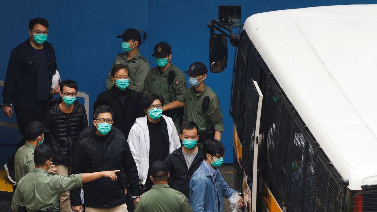 Pro-democracy activists Ventus Lau Wing-hong, Kwok Ka-ki, Lam Cheuk-ting and Raymond Chan Chi-chuen walk to a prison van to head to court with other activists, over a national security law charge, in Hong Kong