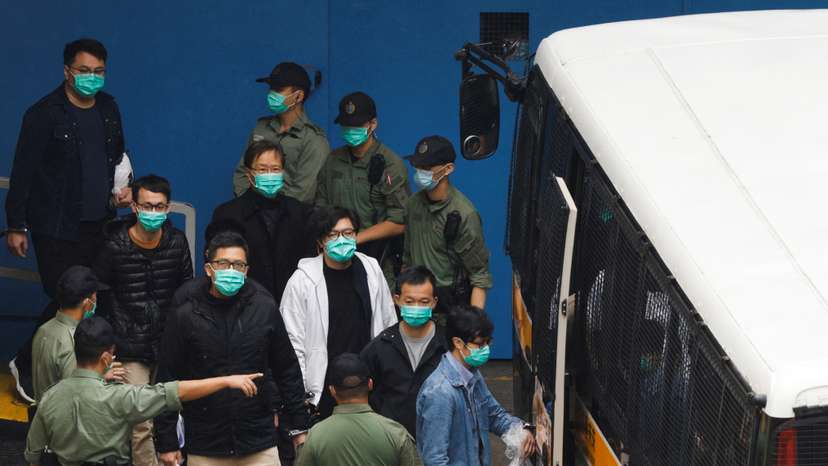 Pro-democracy activists Ventus Lau Wing-hong, Kwok Ka-ki, Lam Cheuk-ting and Raymond Chan Chi-chuen walk to a prison van to head to court with other activists, over a national security law charge, in Hong Kong