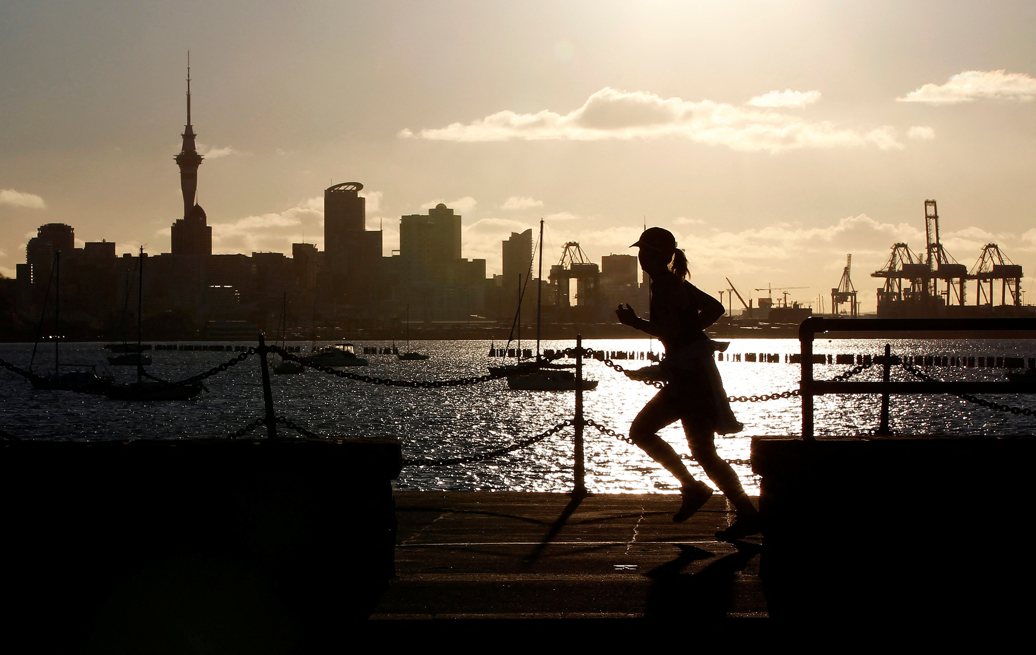 FILE PHOTO: A jogger runs along the seawall in Auckland