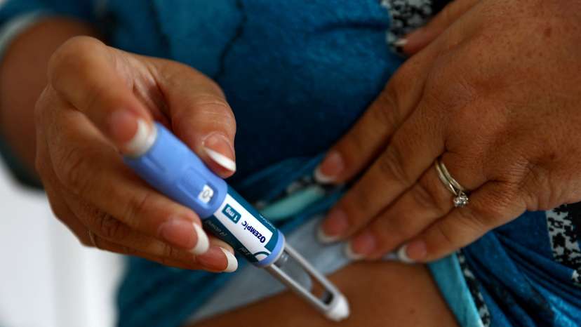 Kim Gradwell injects a dose of Ozempic at her home in Dudley