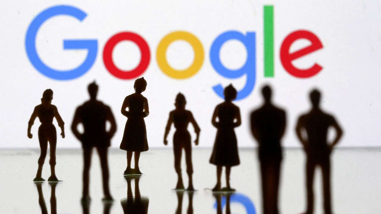 FILE PHOTO: Small toy figures are seen in front of Google logo in this illustration picture