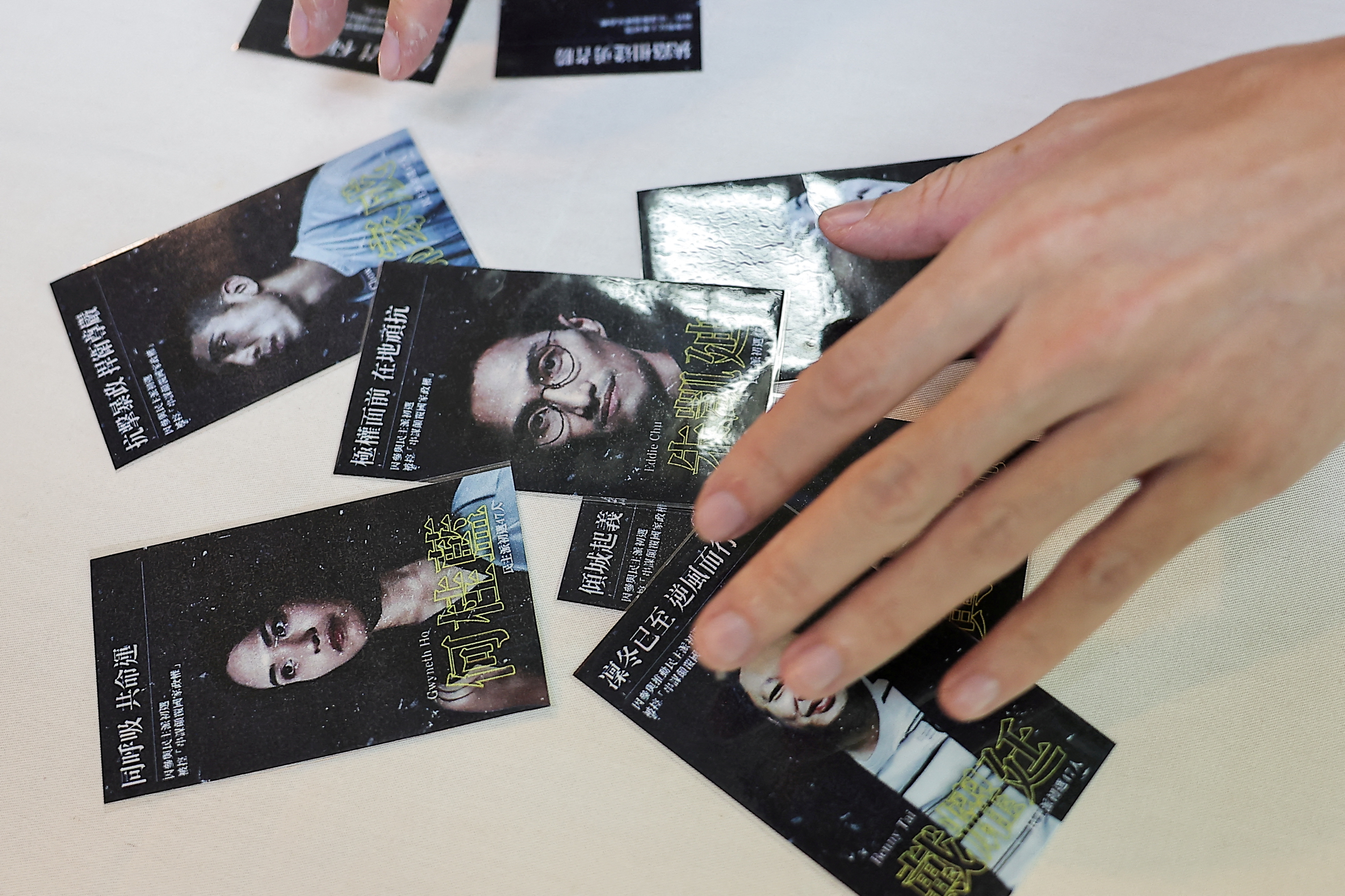 Sky Fung, Secretary-General, Hong Kong Outlanders, shows cards with pictures of activists as he holds a press conference in Taipei