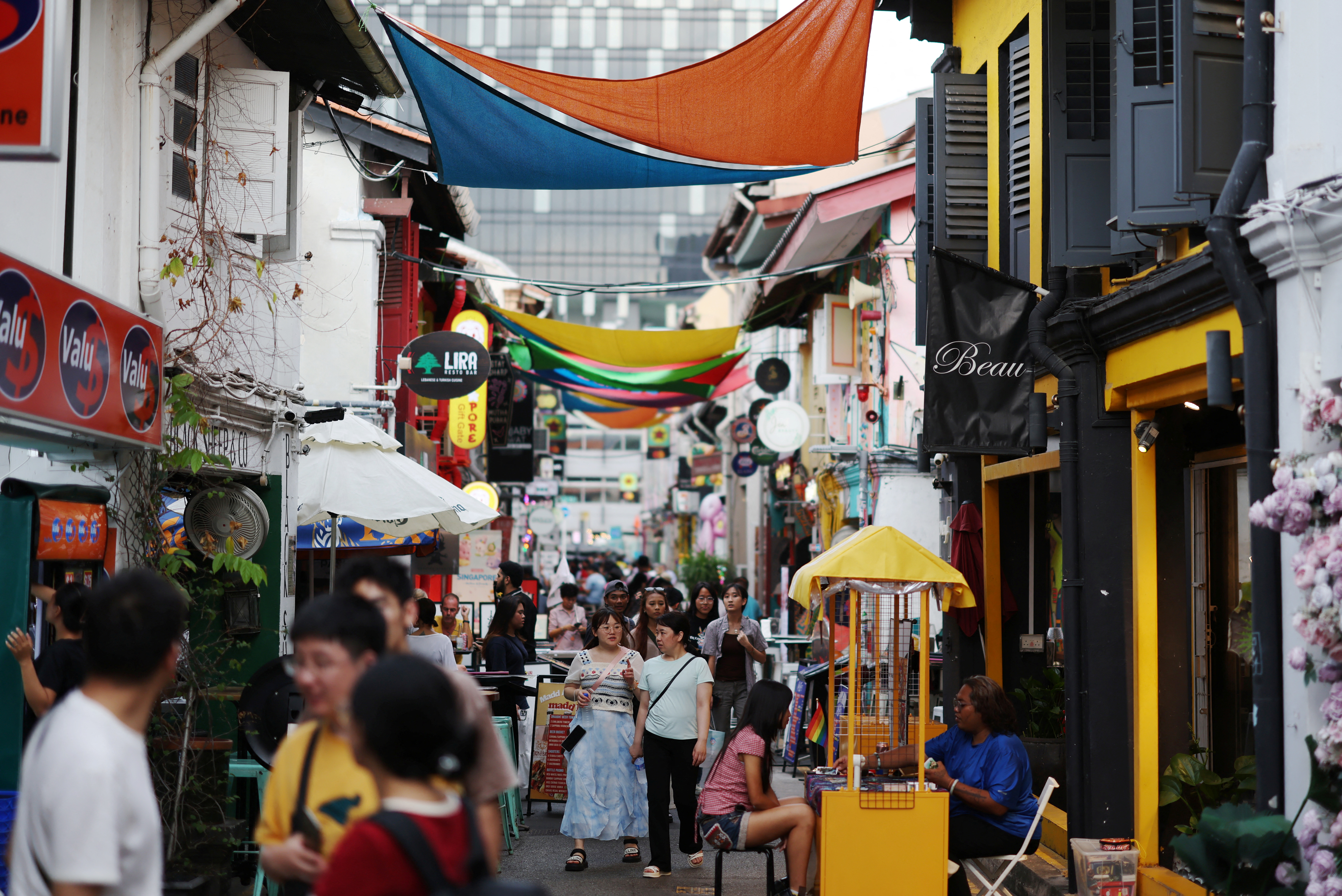 People walk through a shopping street at Kampong Glam district in Singapore