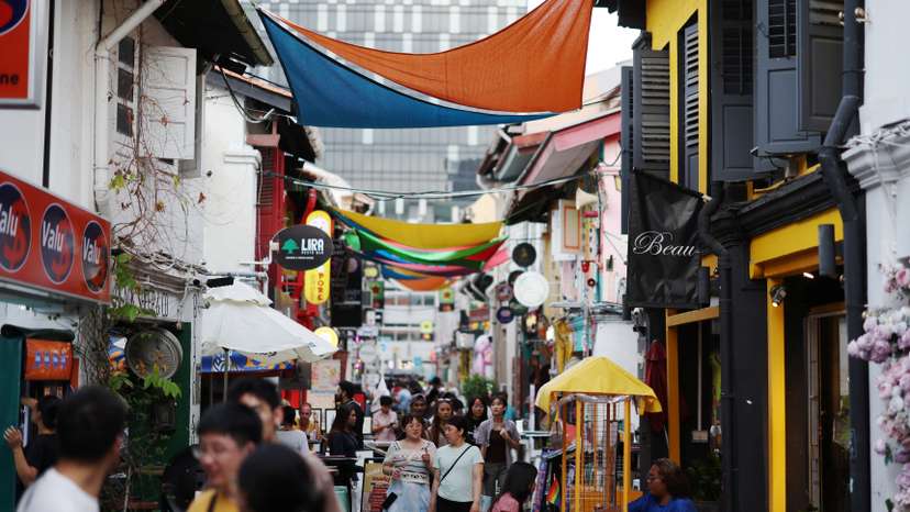 People walk through a shopping street at Kampong Glam district in Singapore