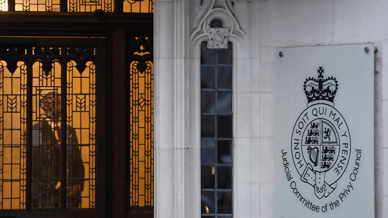 FILE PHOTO: A member of security stands guard inside the Supreme Court in London