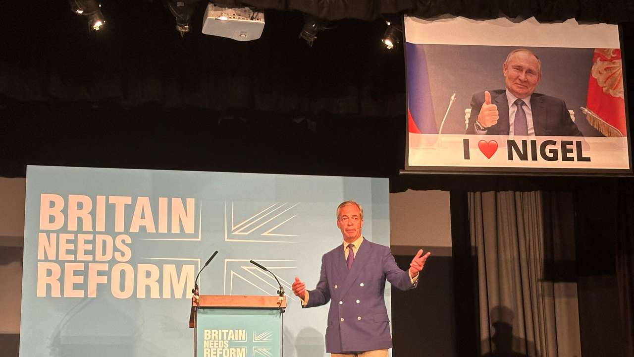 A remote-controlled screen operated by the political activist group, Led By Donkeys, lowers as Reform UK leader Nigel Farage speaks in Walton-on-the-Naze