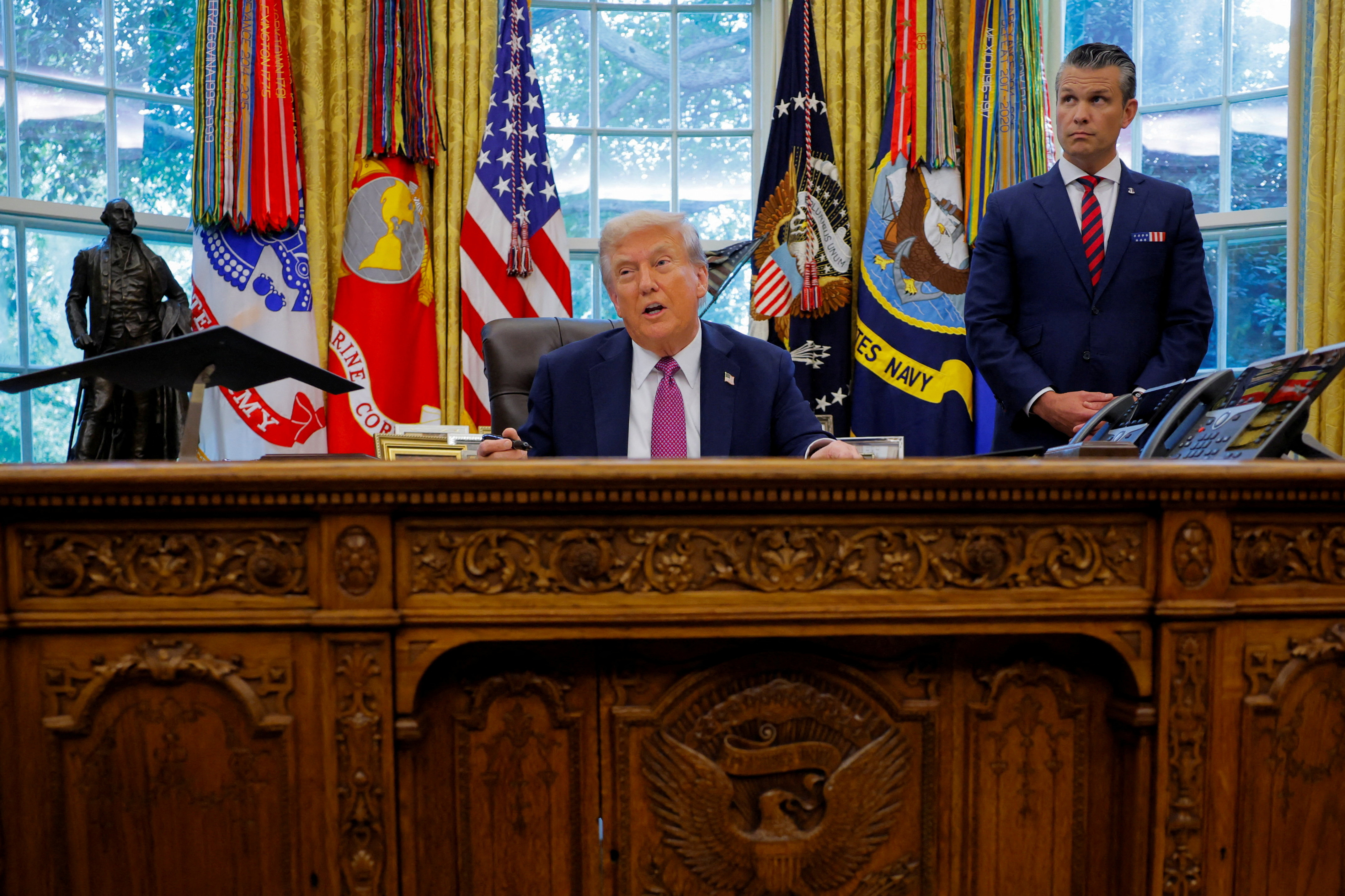 FILE PHOTO: U.S. President Donald Trump signs an executive order at the White House in Washington, D.C.