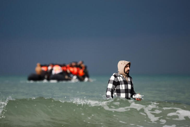 Migrants attempt to cross the English Channel, on the beach of the Slack dunes in Wimereux